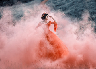Lady in a luxury lush red dress swirls in the smoke,fantastic shot,fairytale princess is walking in the autumn forest,fashionable toning,creative computer colors