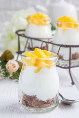 Breakfast dessert with bran flakes, plain yogurt and mango