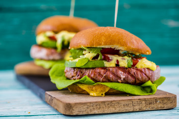 Tasty grilled tuna burgers with lettuce and mayonnaise
