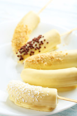 Banana covered in chocolate on a blue wooden table