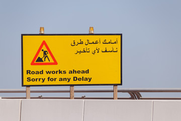 road sign Road Works Ahead in English and Arabic