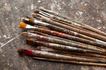 Art materials. Different brushes  on the gray sloppy surface