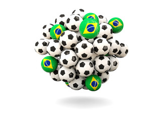 Pile of footballs with flag of brazil