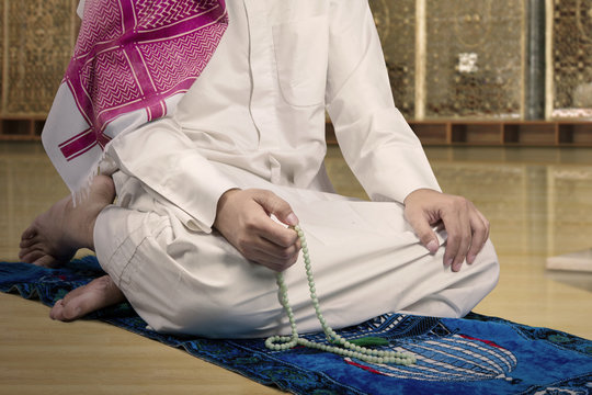 Devout muslim man dhikr in the mosque