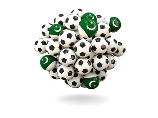 Pile of footballs with flag of pakistan