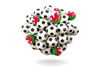 Pile of footballs with flag of wales