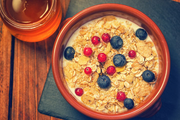 Healthy Breakfast Muesli with berries,honey and milk 