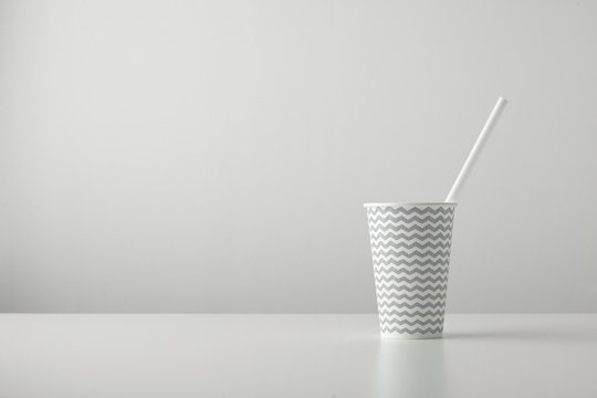 One Paper Cup Decorated With Gray Black Line Pattern And With White Drinking Straw Inside Isolated On Table Place For Your Text Above