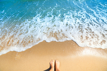 Sea foam, waves and naked feet on a sand beach © Taiga