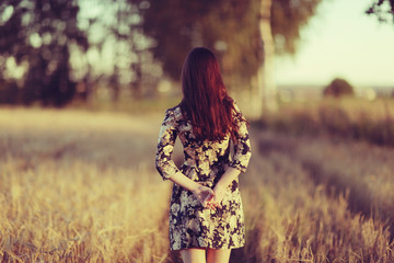 Girl in dress on the summer road