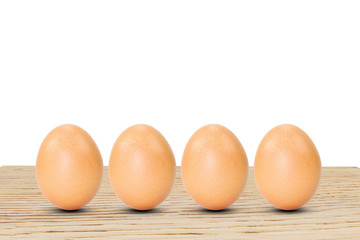 Fresh eggs with soft shadow on wooden vintage floor on white background
