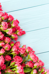 Roses on wooden background
