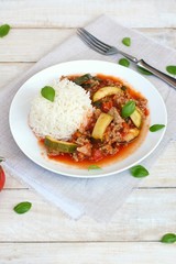 Spicy mincemeat with tomatoes, basil and zucchini with basmati rice