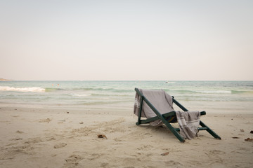 Fototapeta na wymiar beach chair with shawl sit on sea beach view. tone and vignette 