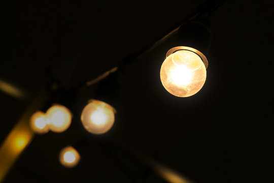 small luminous light bulbs are hanging in dim place.
like found idea from thinking in unclear situation solve the problem or way to be creative and success