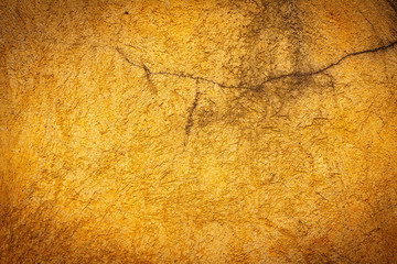 Abstract background texture cement wall in  orange yellow tone. Grunge wall texture in orange yellow tone. Cement texture and background with copy space for text or image. Center focus. Blurry edges.