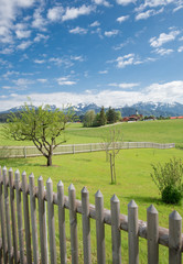 Idyllische Allgäu-Landschaft, Gartenzaun im Vordergrund