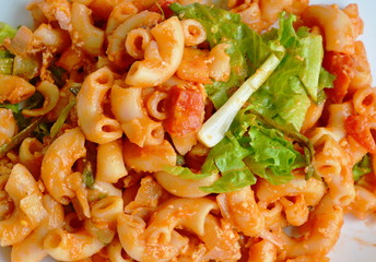 stir fried macaroni with egg and ketchup on white plate