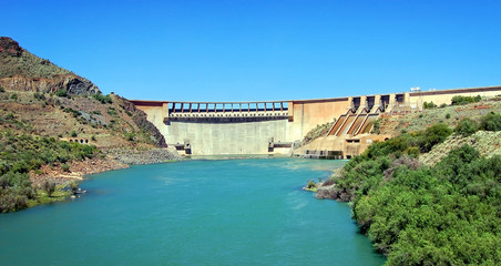 Dam in Karoo (semi desert) in South Africa on a background of beautiful blue sky and turquoise water.