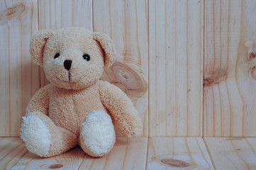 Teddy bear on wooden background. Lonely. Greeting card on wood.