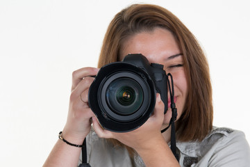 Female photographer holding a professional camera - isolated over white