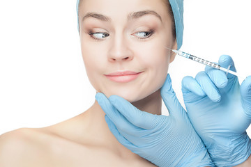 Attractive woman at plastic surgery with syringe in her face