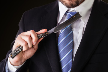 businessman and big straight razor