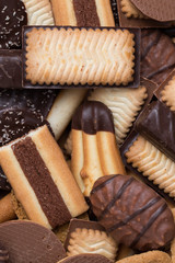 Cookies assorted on black background. Delicious morning snacks for breakfast, brunch and lunch. Appetizing, sweet and fast food.