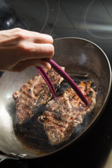 Steak cooking on grille pan. Fresh, delicious, spicy meat on a kitchen with copy space closeup