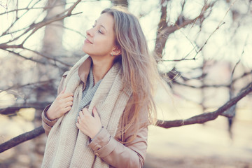 spring photo beautiful girl in a coat in the city