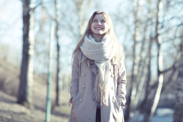 Urban portrait of a happy woman in coat