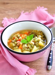 Soup of the rabbit meat with broccoli, green peas, carrots and pasta stars