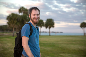 Naklejka premium Young man walking at sundown