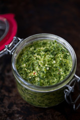 Homemade parsley and basil pesto in a jar