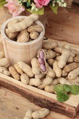 Peanut and boiled peanuts on wood background.