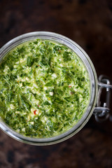 Homemade parsley and basil pesto in a jar