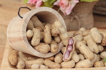 Peanut and boiled peanuts on wood background.