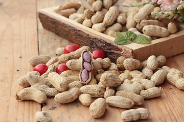 Peanut and boiled peanuts on wood background.