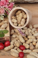 Peanut and boiled peanuts on wood background.