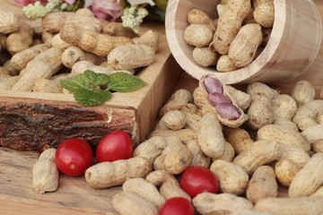 Peanut and boiled peanuts on wood background.
