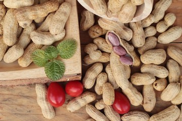 Peanut and boiled peanuts on wood background.