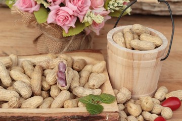 Peanut and boiled peanuts on wood background.