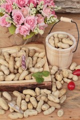 Peanut and boiled peanuts on wood background.