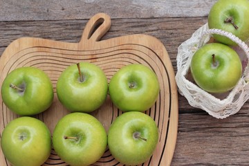 green apples is delicious on wood background.