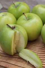 green apples is delicious on wood background.
