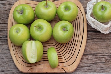 green apples is delicious on wood background.