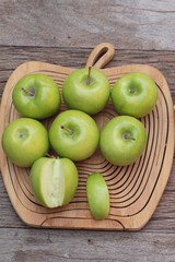 green apples is delicious on wood background.