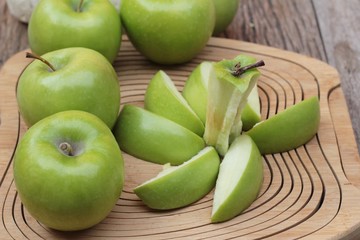 green apples is delicious on wood background.