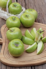 green apples is delicious on wood background.