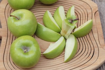 green apples is delicious on wood background.